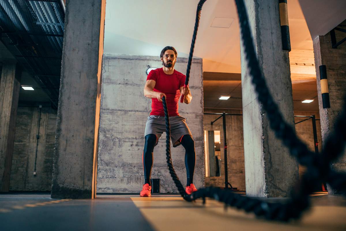 Shot of a sporty young man working out with battle ropes at the gym | Enzymes… A Health Miracle? | Enzymes