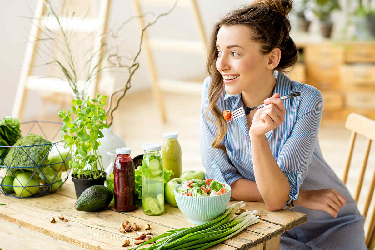 Young happy woman eating healthy salad | Why Gut Health Matters More Than You Think