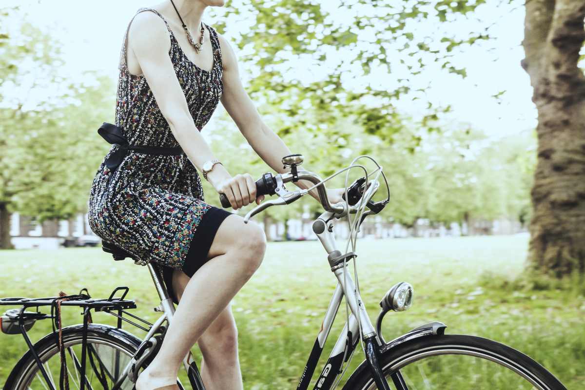 woman riding a bike | Tips To Keep The Stress Away During Busy Summer Months | remove stress