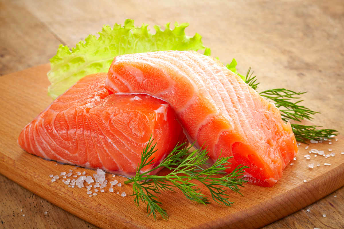 Fresh raw salmon on wooden cutting board | Foods To Boost Your Brain Power