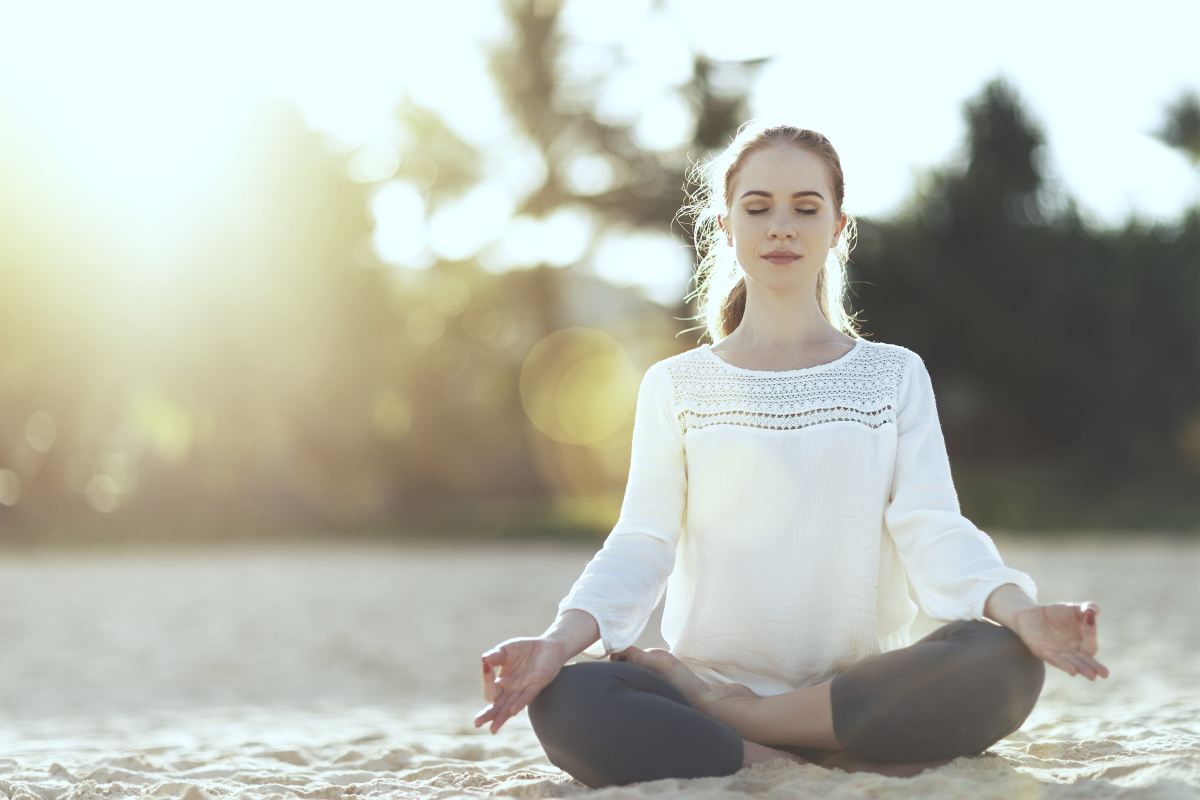 woman meditating | Tips To Keep The Stress Away During Busy Summer Months | how to relieve stress